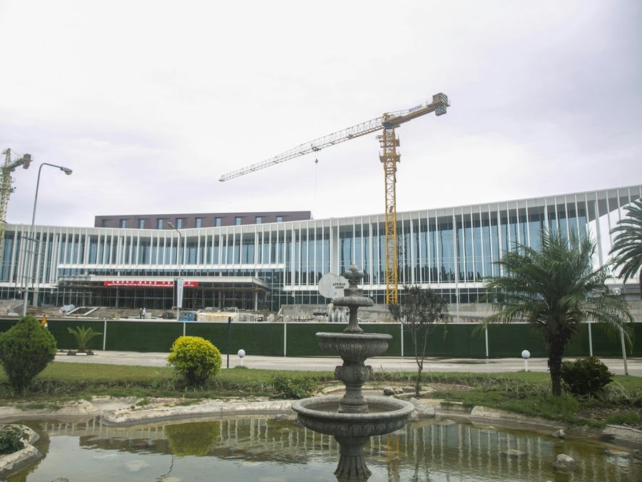 A large commercial building with tower cranes under construction in Lusaka, Zambia